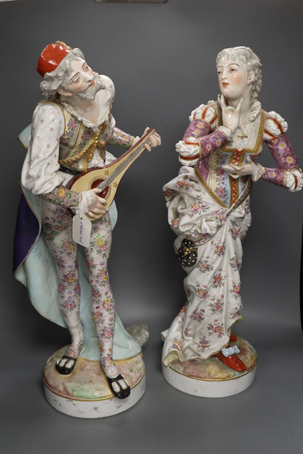 A pair of large 19th century Paris porcelain figures of a mandolin player and a woman dancer, printed anchor mark, 63.5cm